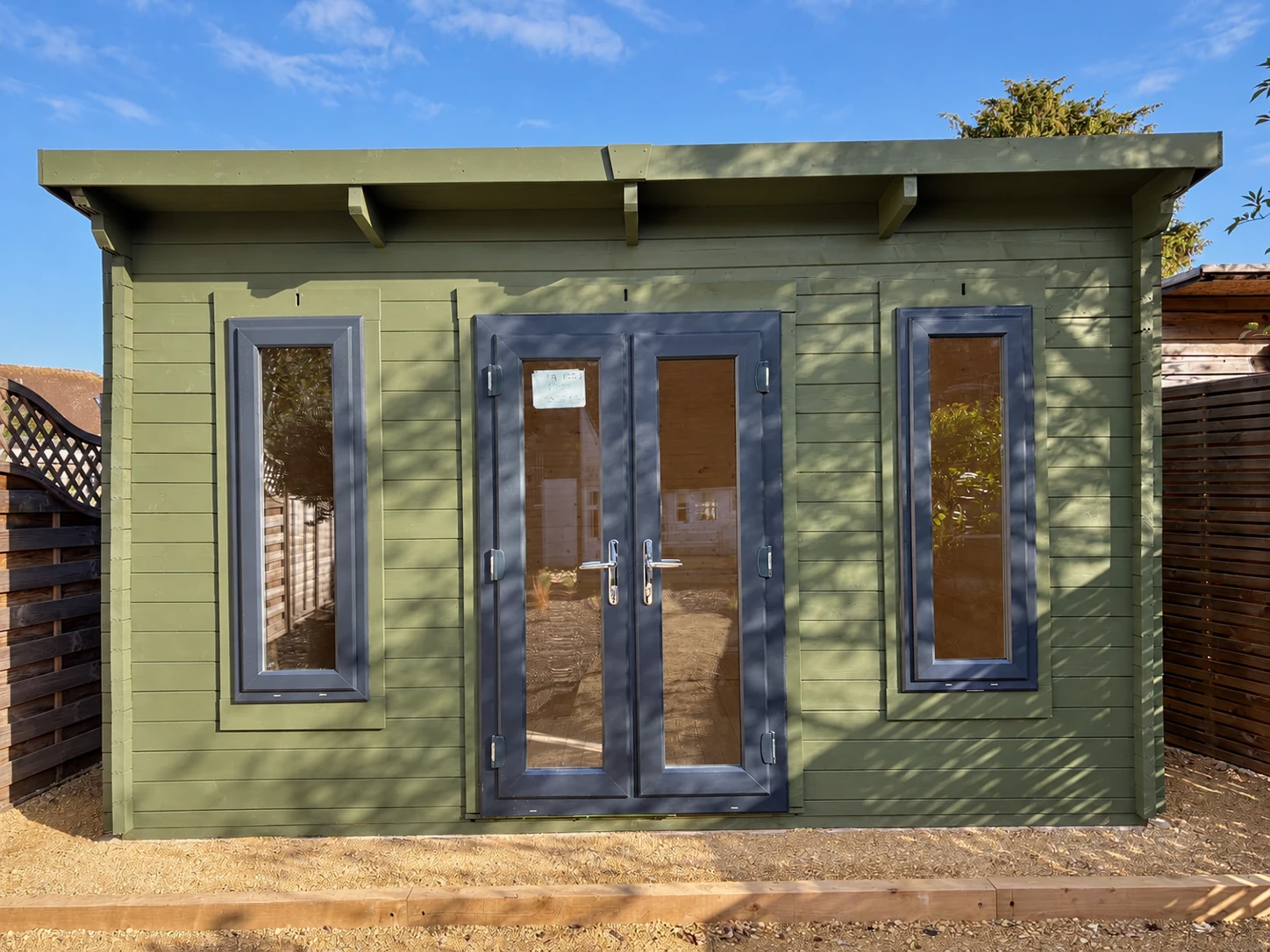 Close view of the garden room facade, double doors and tall windows